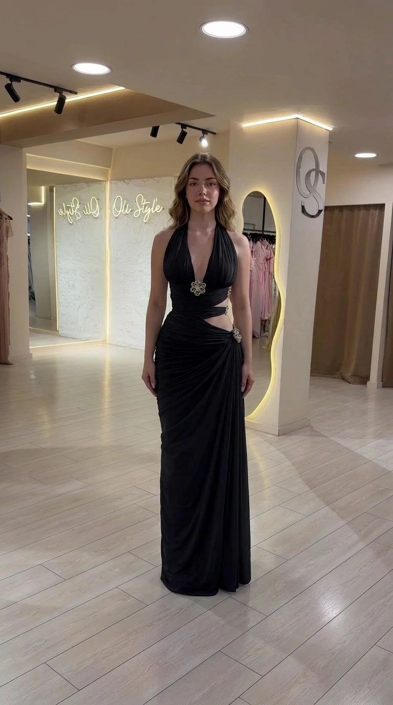Model wearing black halter neck ruched cutout evening gown
