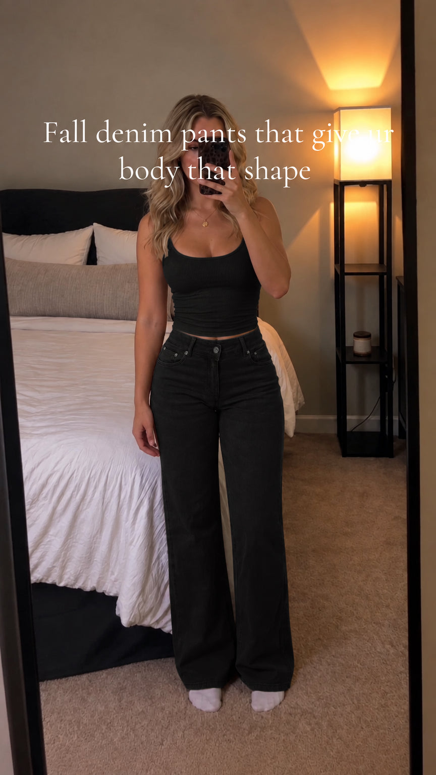 Front full-length view of woman wearing black high-waisted wide-leg denim pants