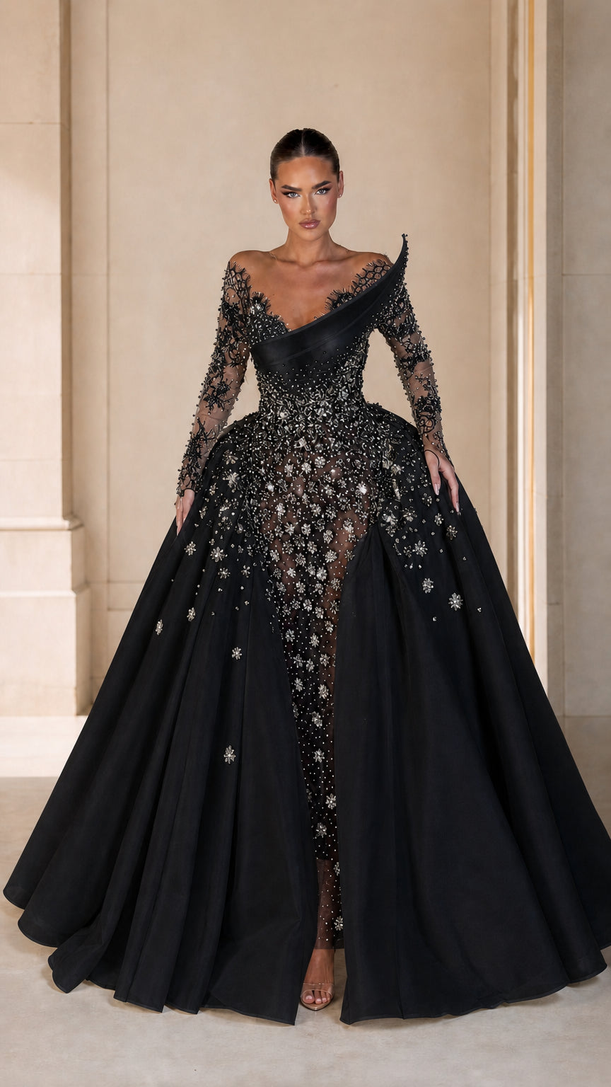 Front view of model wearing black sequin embellished formal gown with full overskirt