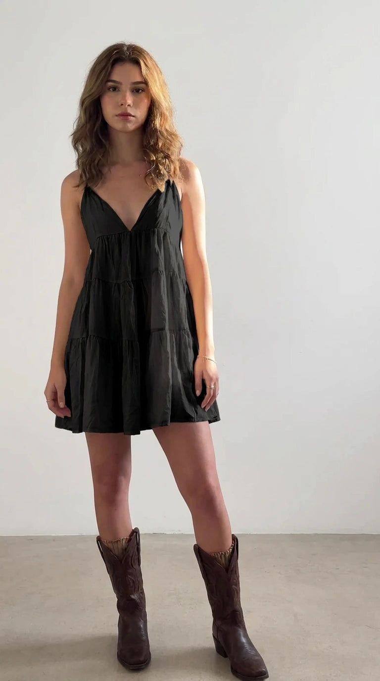 Model wearing black tiered crinkle cotton cami mini dress