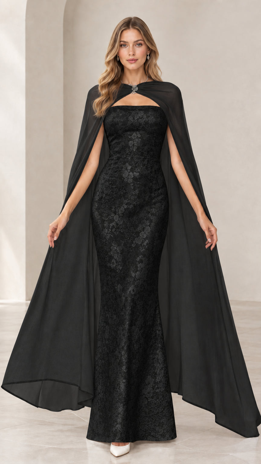 Model wearing black strapless lace mermaid gown with sheer black full-length cape