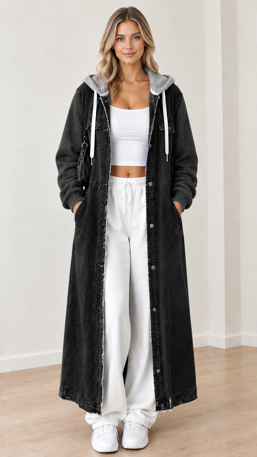 Front view of washed black maxi hooded denim coat with gray sweatshirt sleeves
