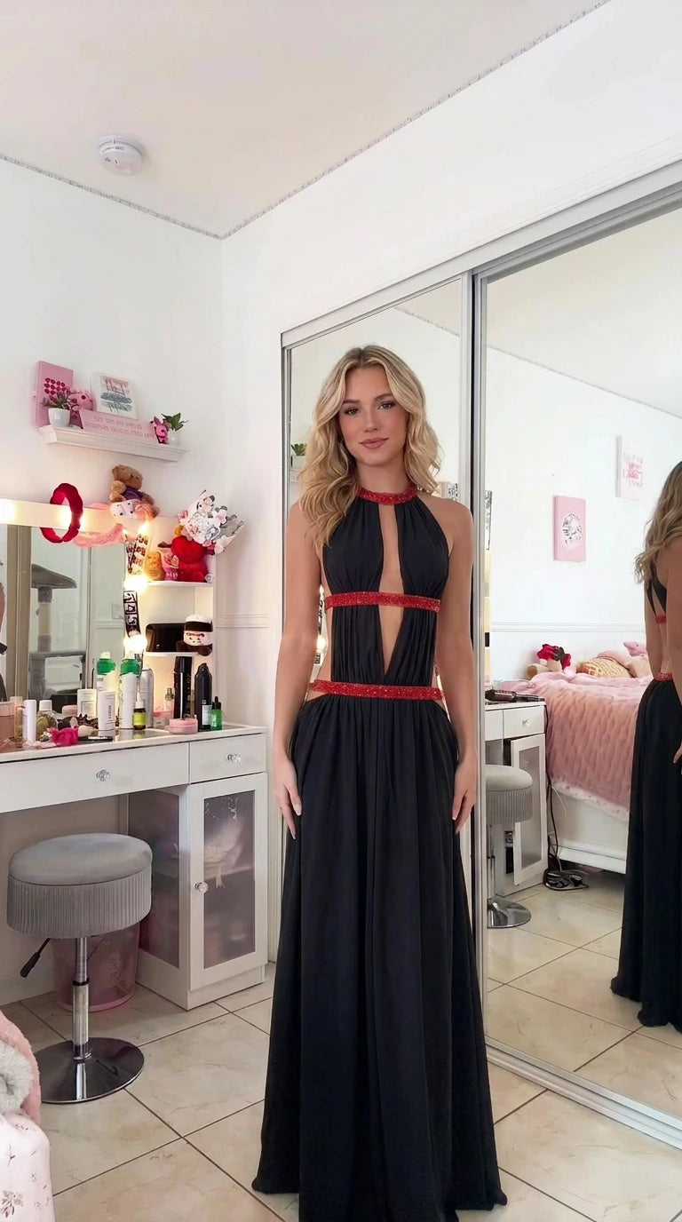 Model wearing black halter cutout evening maxi gown with contrasting red beaded trim