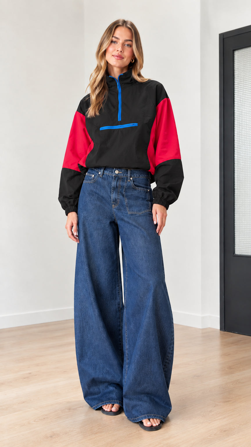 Woman wearing black and red color-block half-zip windbreaker pullover with blue zipper detail