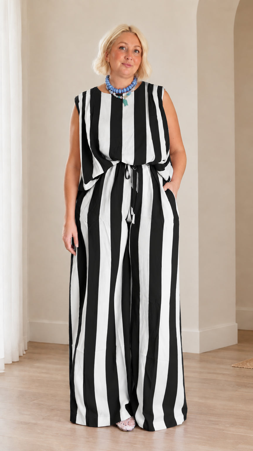 Full front view of woman wearing black and white striped sleeveless top and wide leg pants set