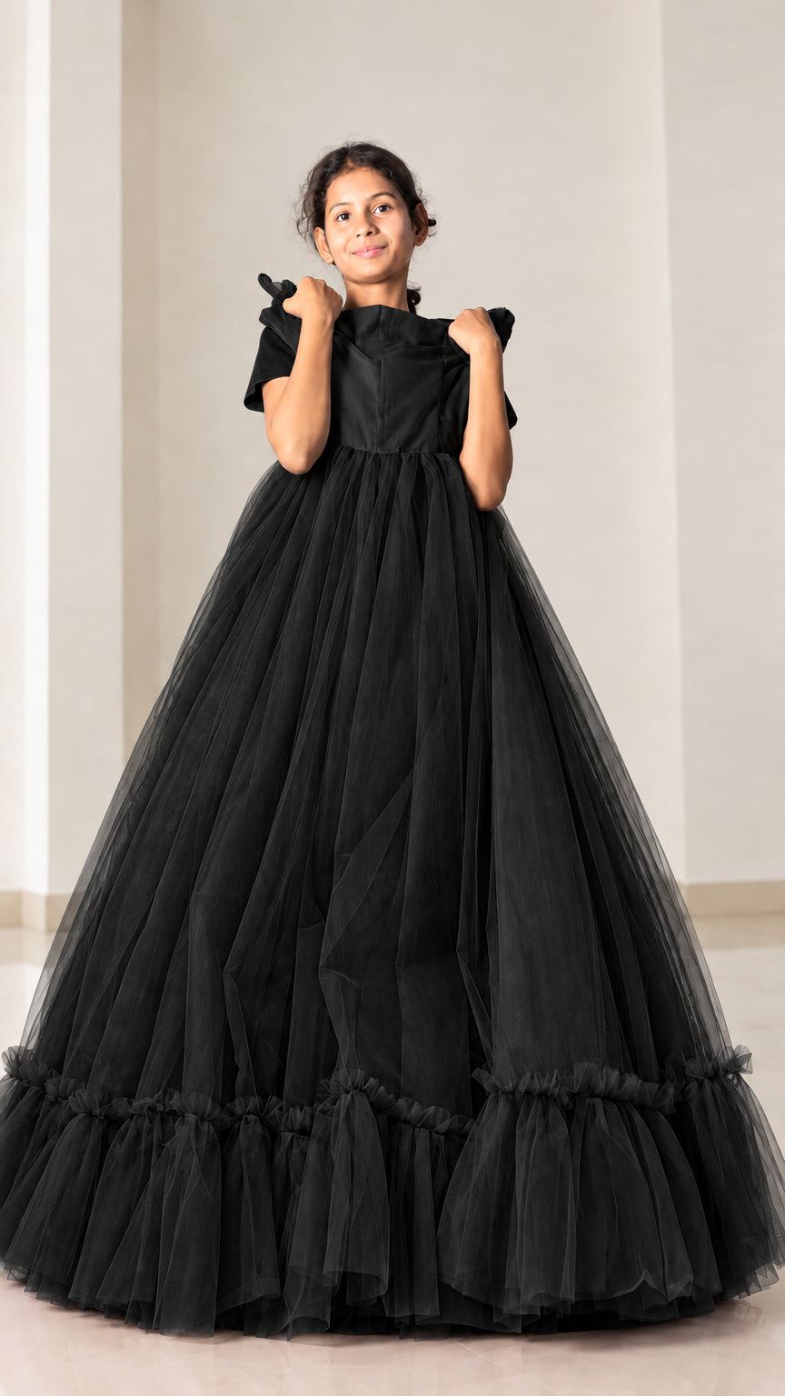 Front view of model wearing black layered tulle maxi ball gown