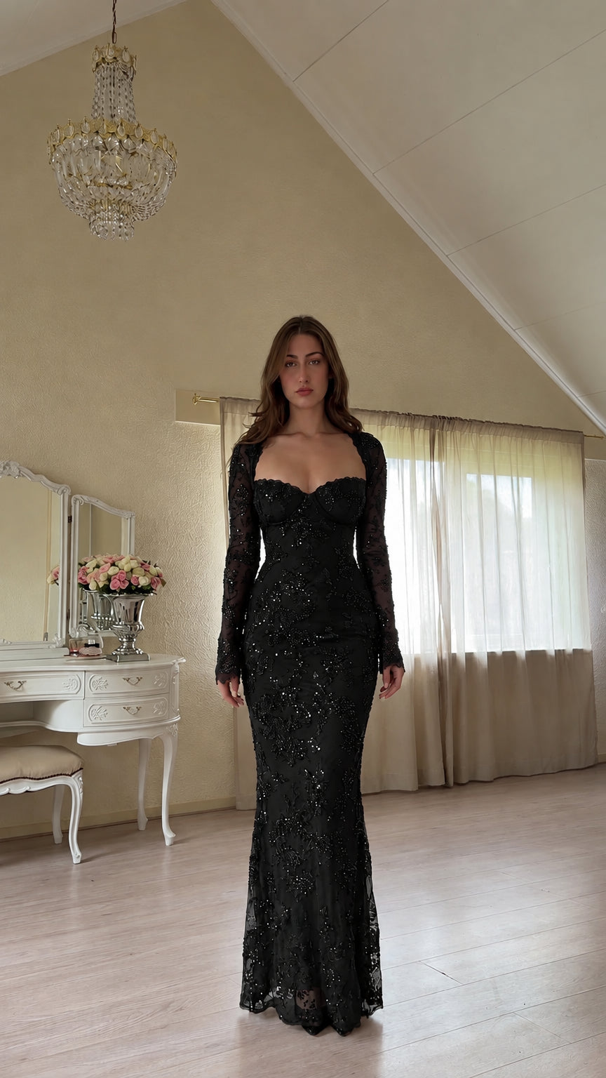 Front view of woman wearing black long sleeve beaded lace sweetheart evening gown
