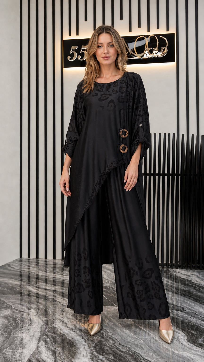 Front view of woman wearing black asymmetrical tunic and wide-leg pants set