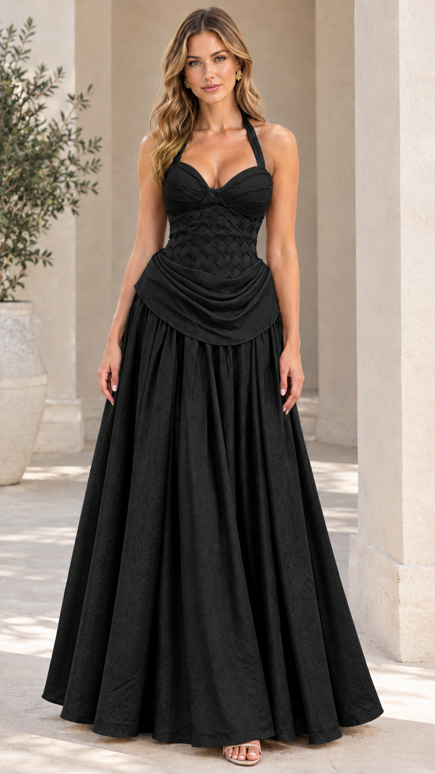 Model wearing the halter neck woven corset evening gown in classic black