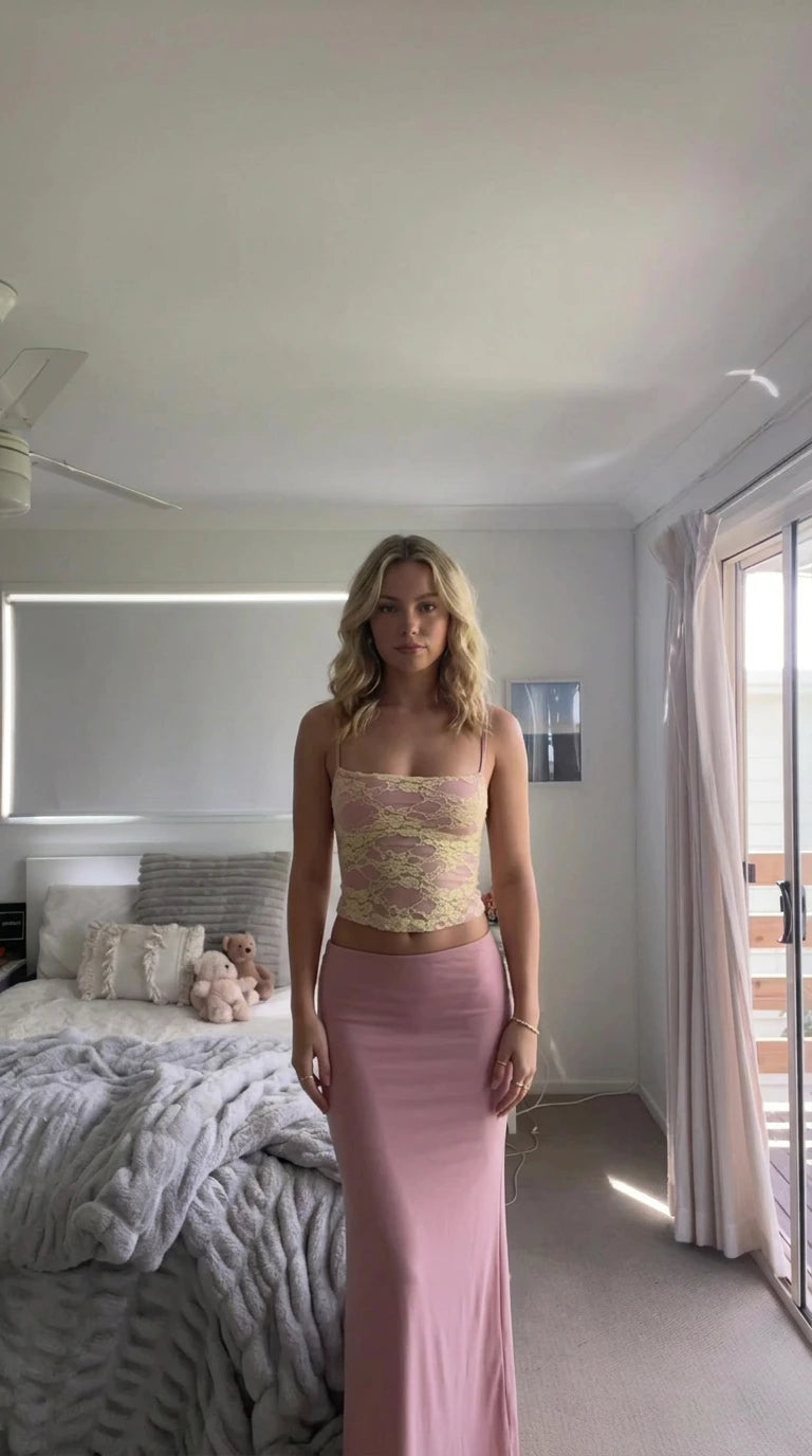 Model wearing dusty pink lace crop top and matching column maxi skirt set
