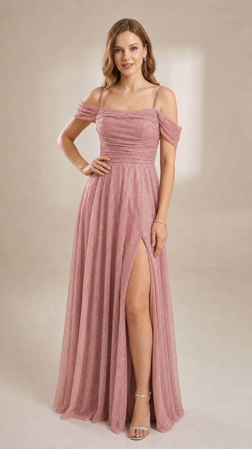 Model in a dusty rose pink sparkling formal gown with off-the-shoulder draped sleeves