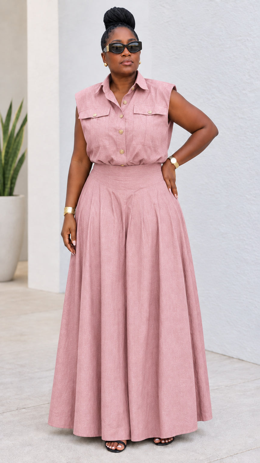 Model wearing dusty pink sleeveless shirt and pleated palazzo pant set