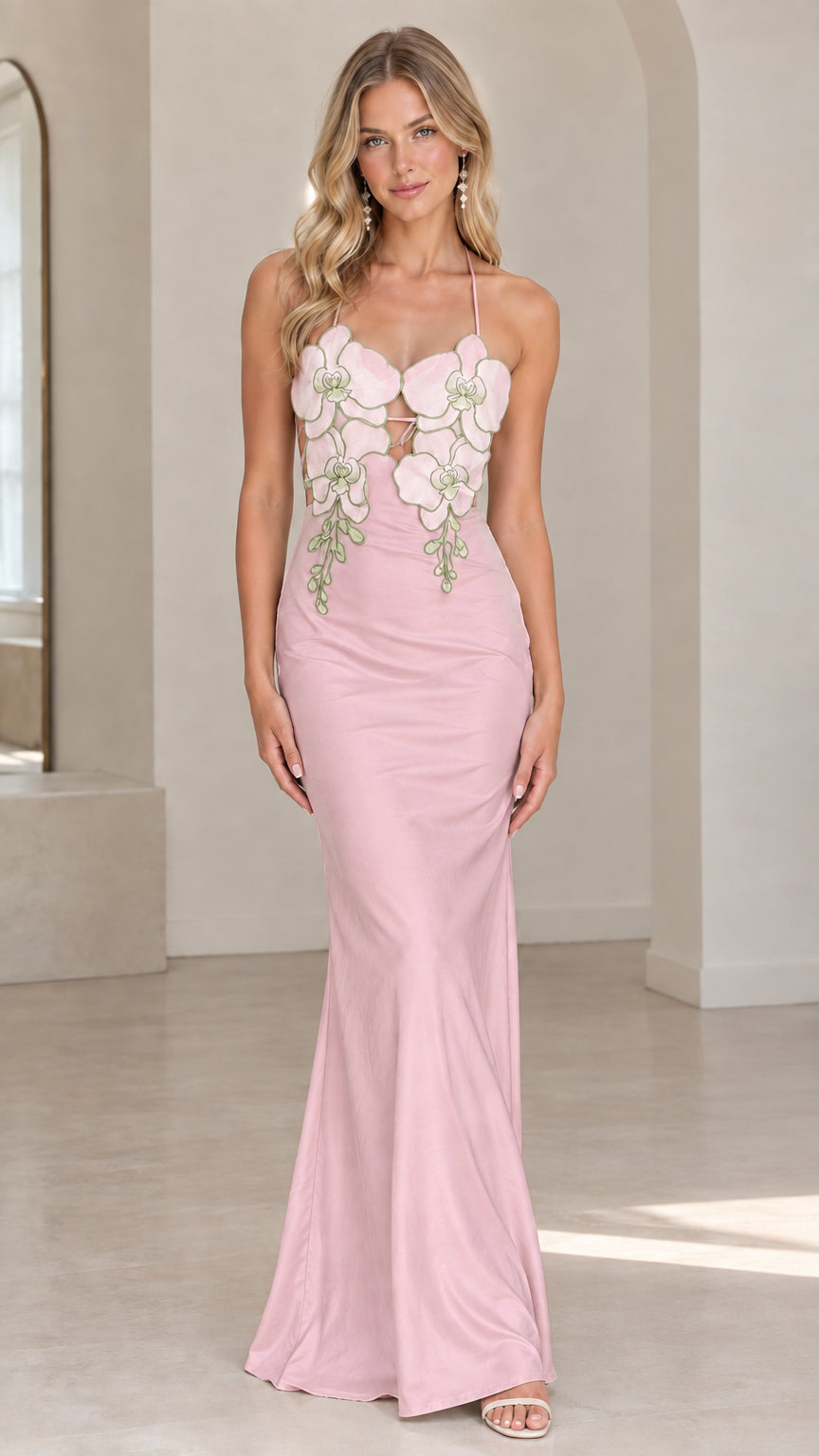 Front view of model wearing blush pink satin halter maxi dress with floral appliqués