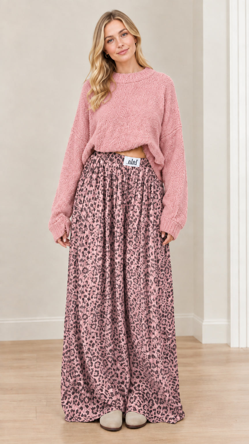 Model wearing dusty pink knit sweater paired with rose pink leopard print wide-leg trousers