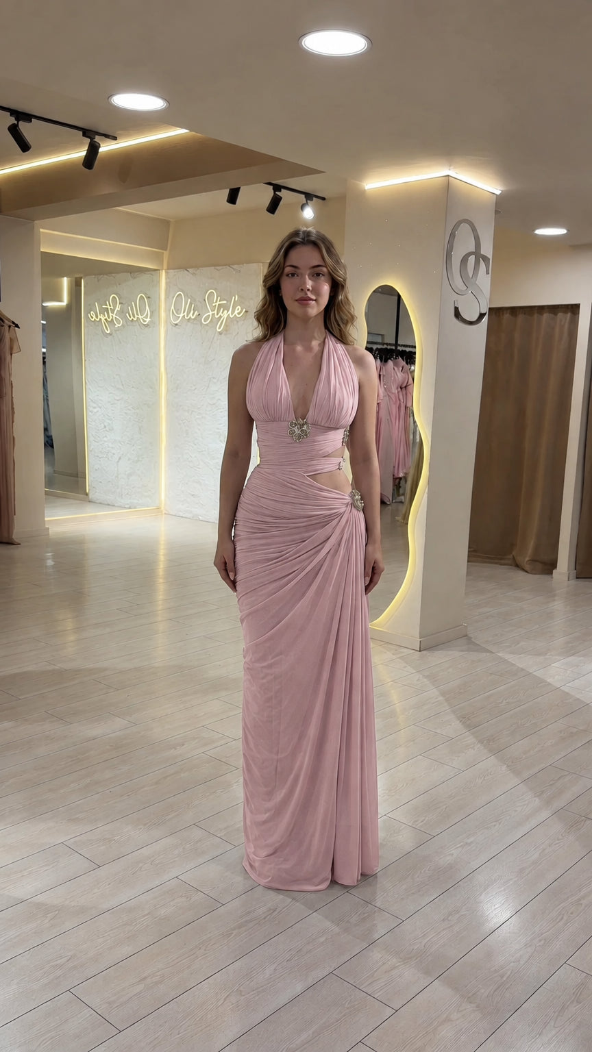 Model wearing blush pink halter neck ruched cutout formal dress