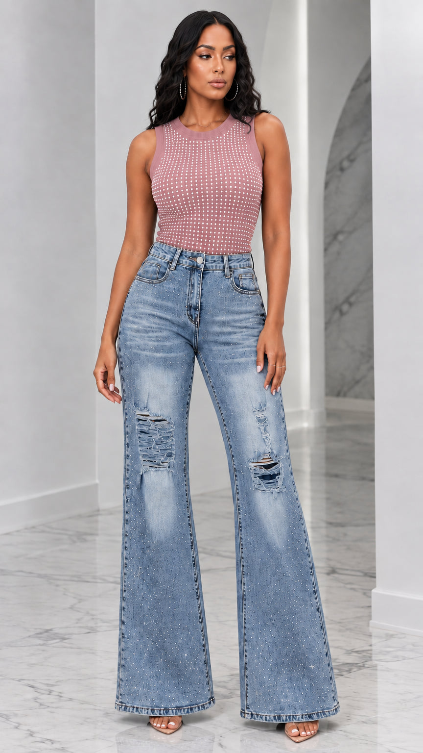 Full-length view of woman wearing dusty rose rhinestone tank top and distressed flare jeans