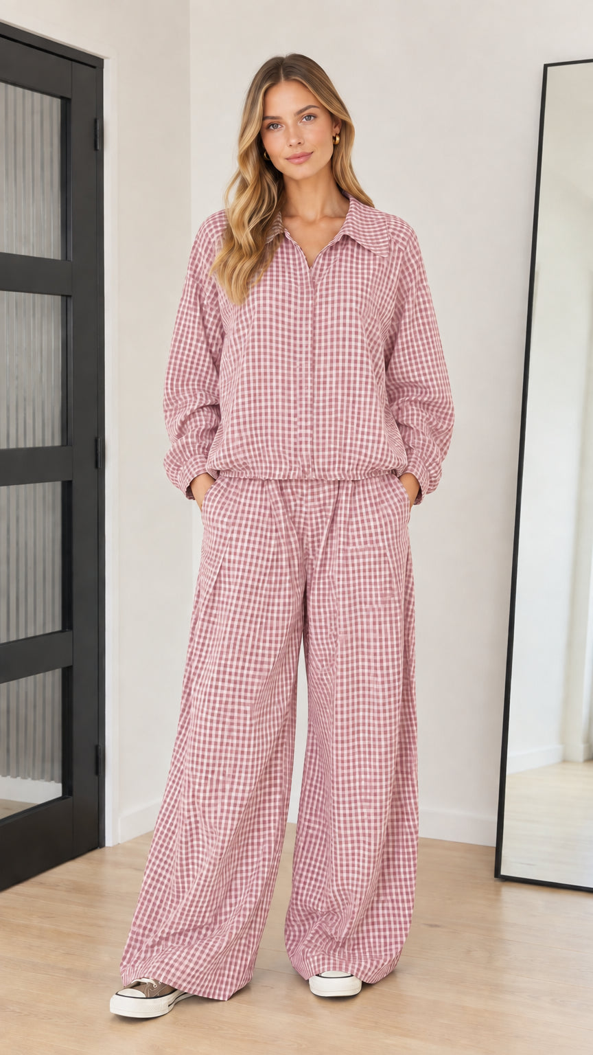 Front full-length view of model wearing dusty pink gingham collared top and wide-leg pants set