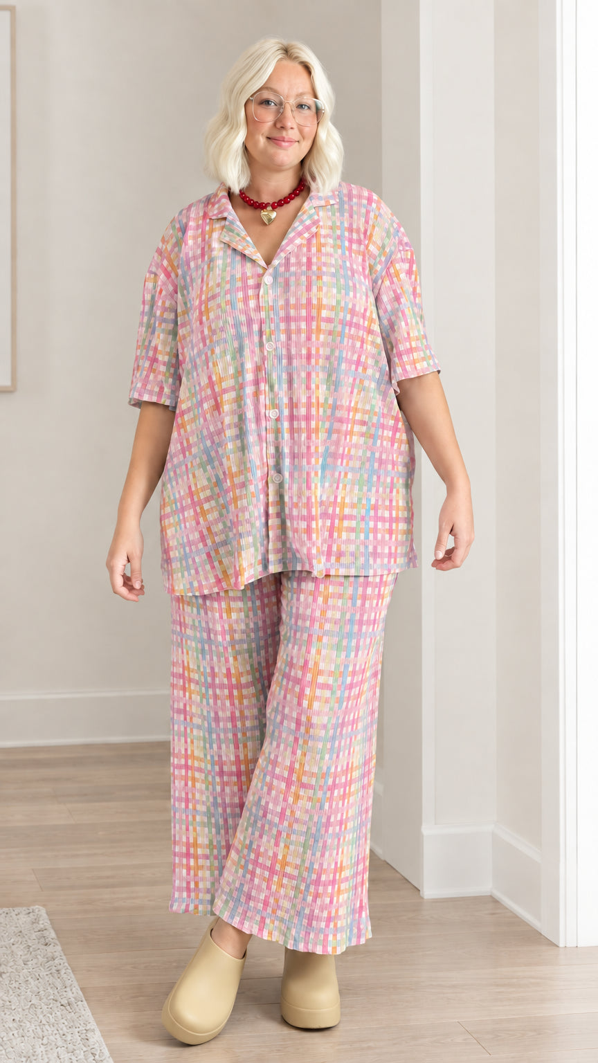 Model wearing pink multicolor plaid plissé shirt and matching wide-leg pants