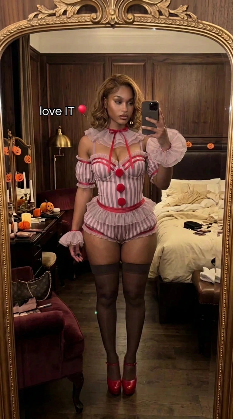 Front mirror selfie of model wearing pink striped clown romper costume with ruffled collar