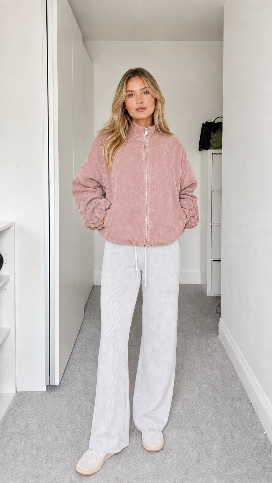 Full-body view of model wearing dusty pink fleece zip-up jacket