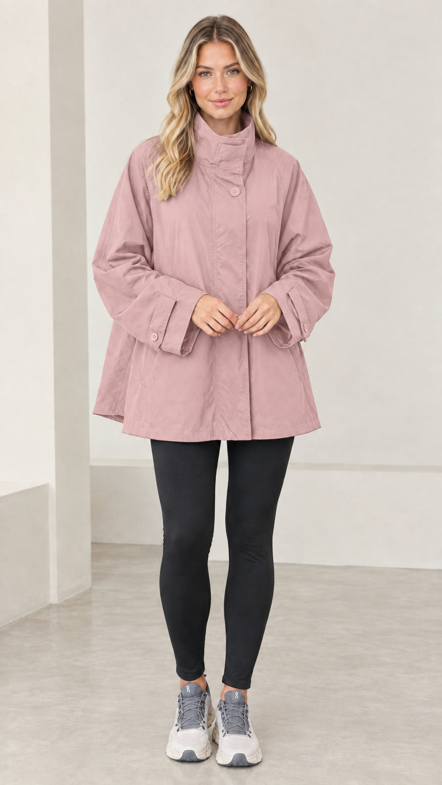 Front view of model wearing dusty pink stand collar swing jacket with leggings