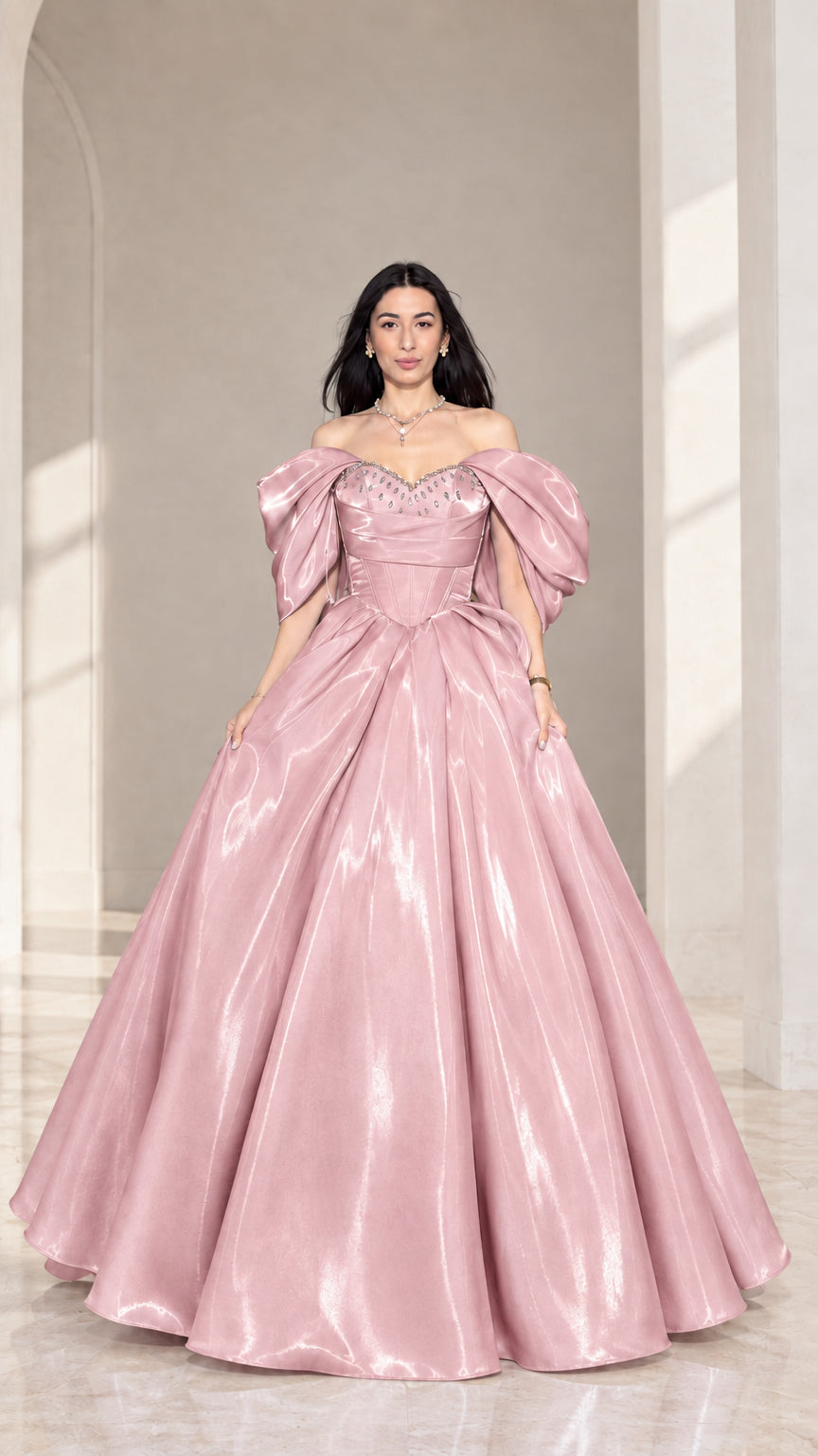 Front view of model wearing blush pink off-shoulder beaded corset ball gown