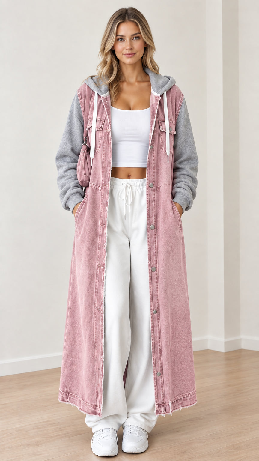 Front view of dusty pink maxi hooded denim coat with contrast heather gray knit sleeves