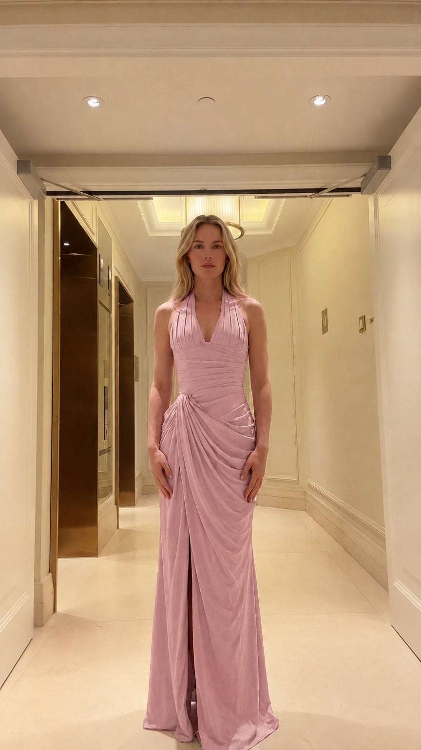 Front view of woman wearing dusty pink halter neck ruched maxi dress