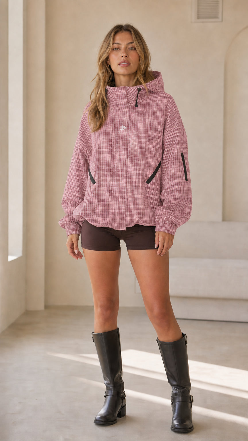 Full front view of woman wearing dusty pink houndstooth hooded jacket