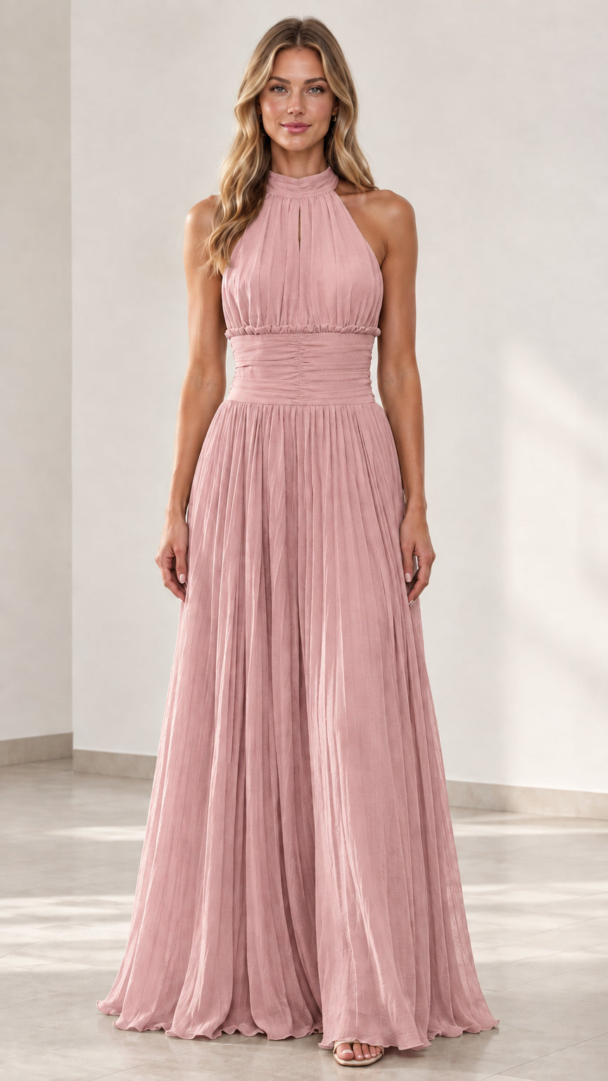 Front view of woman wearing dusty pink halter pleated maxi gown