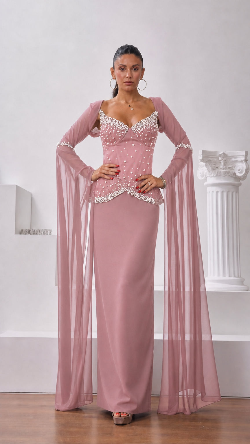 Front view of model wearing dusty pink pearl-embellished maxi gown with sheer wing sleeves
