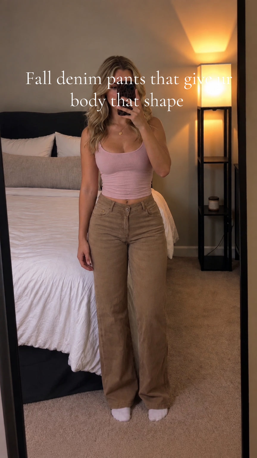 Full-length front view of woman styling khaki brown wide-leg denim pants with pink top
