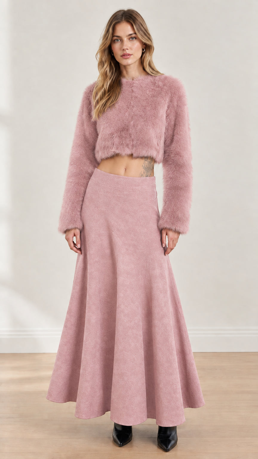 Model wearing dusty pink fuzzy cropped top and matching flared maxi skirt set