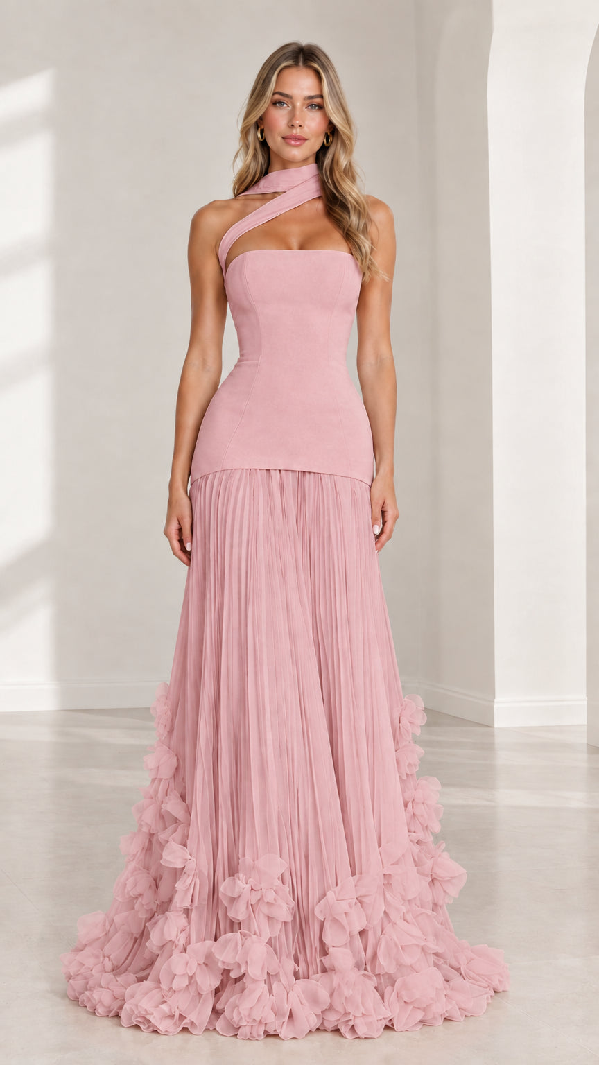 Front full-length view of model wearing blush pink asymmetric drop waist evening gown