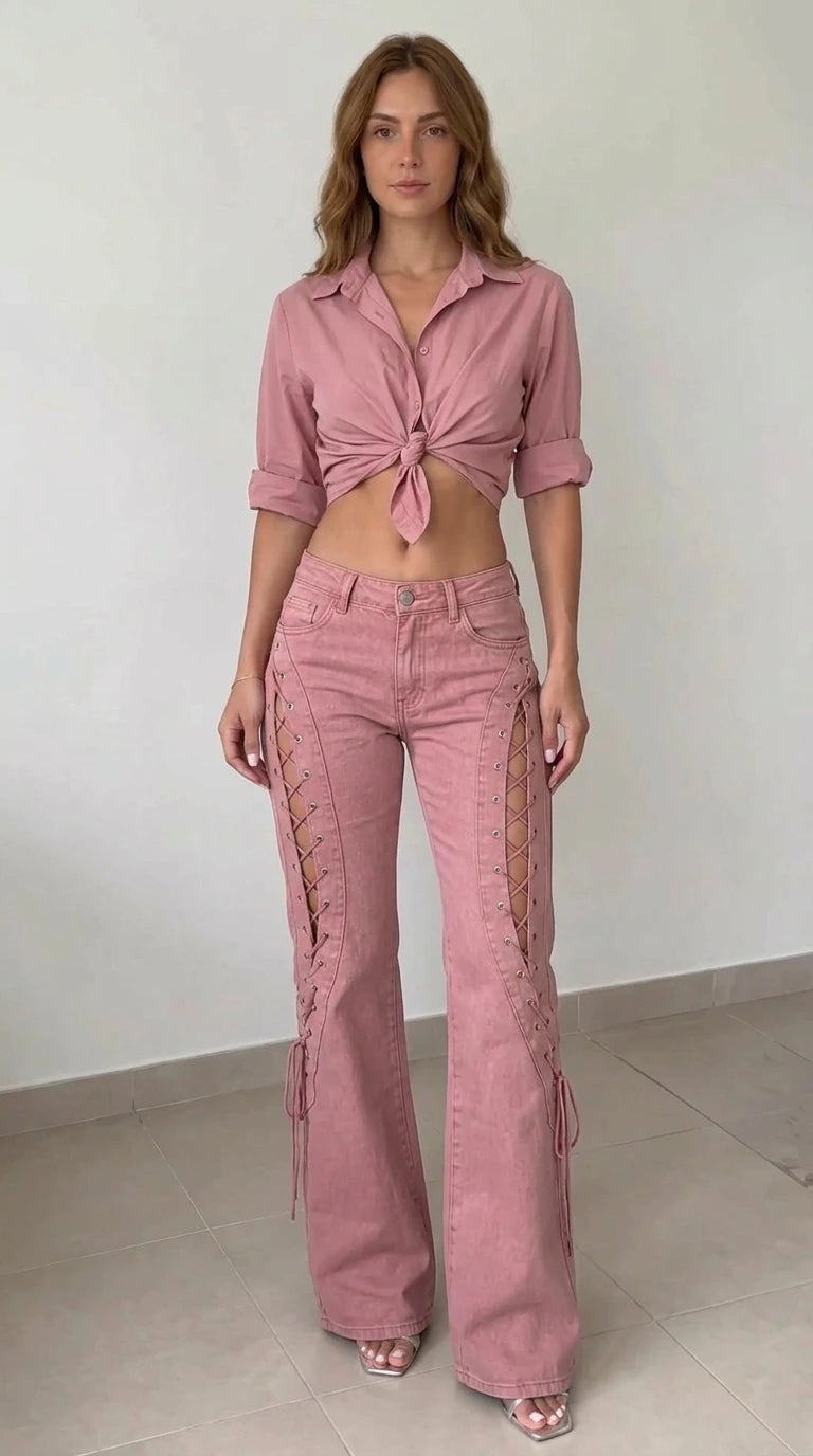 Front view of model wearing dusty pink lace-up cutout flared jeans paired with a matching pink knotted shirt