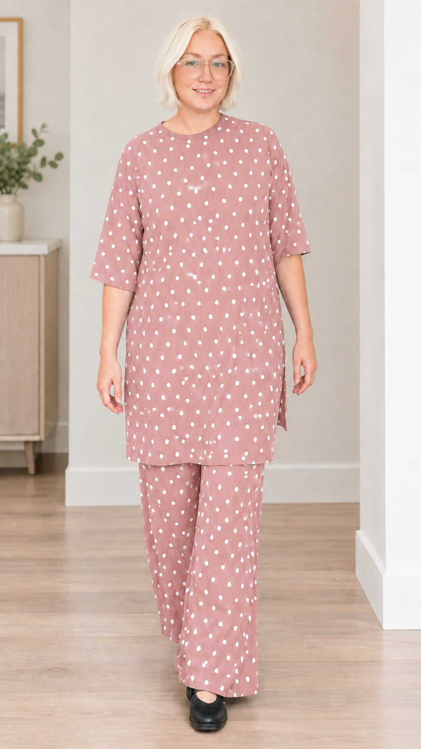 Front view of woman wearing dusty pink polka dot tunic and wide-leg pants set