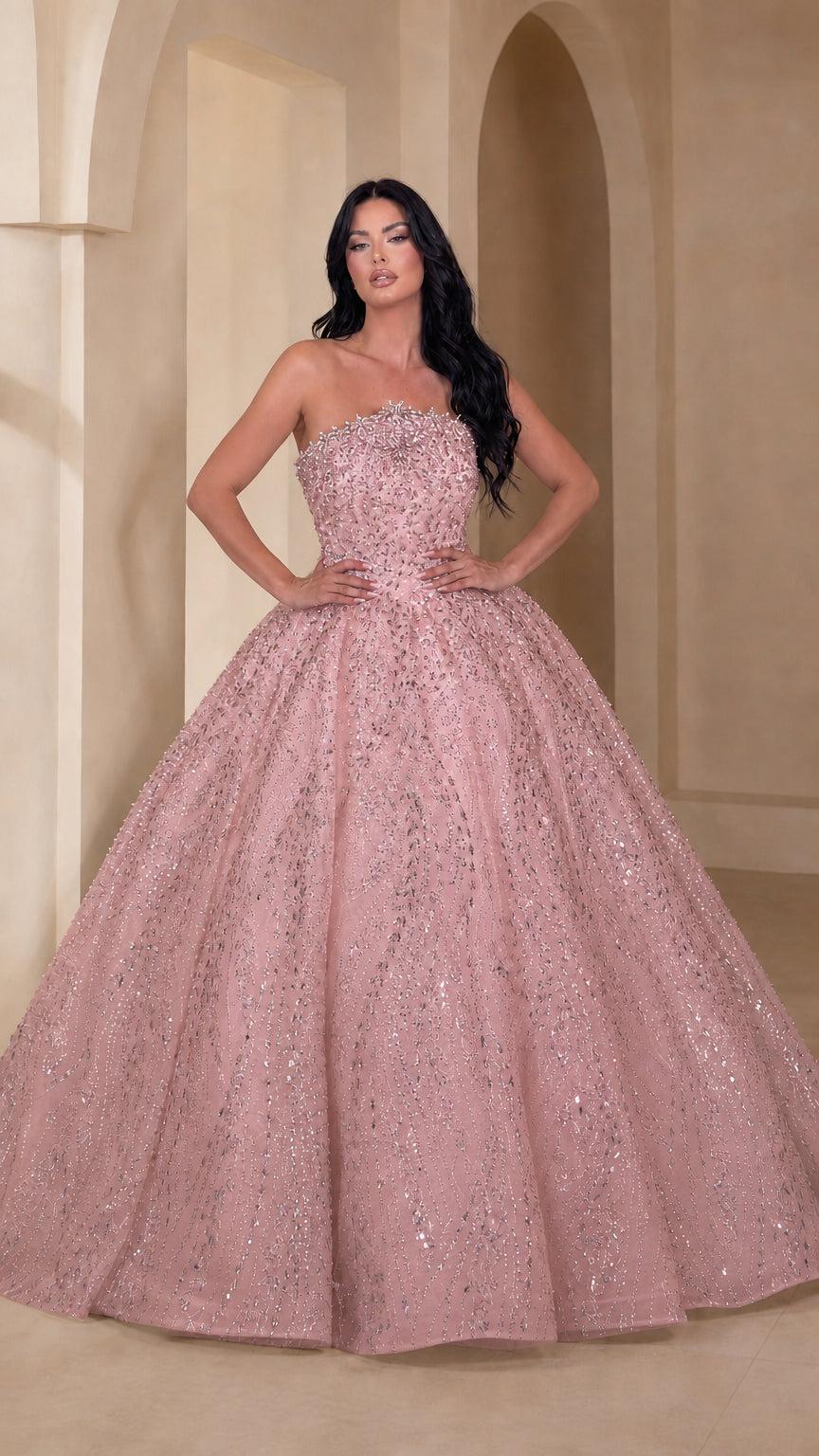 Model wearing blush pink sparkling strapless ball gown dress
