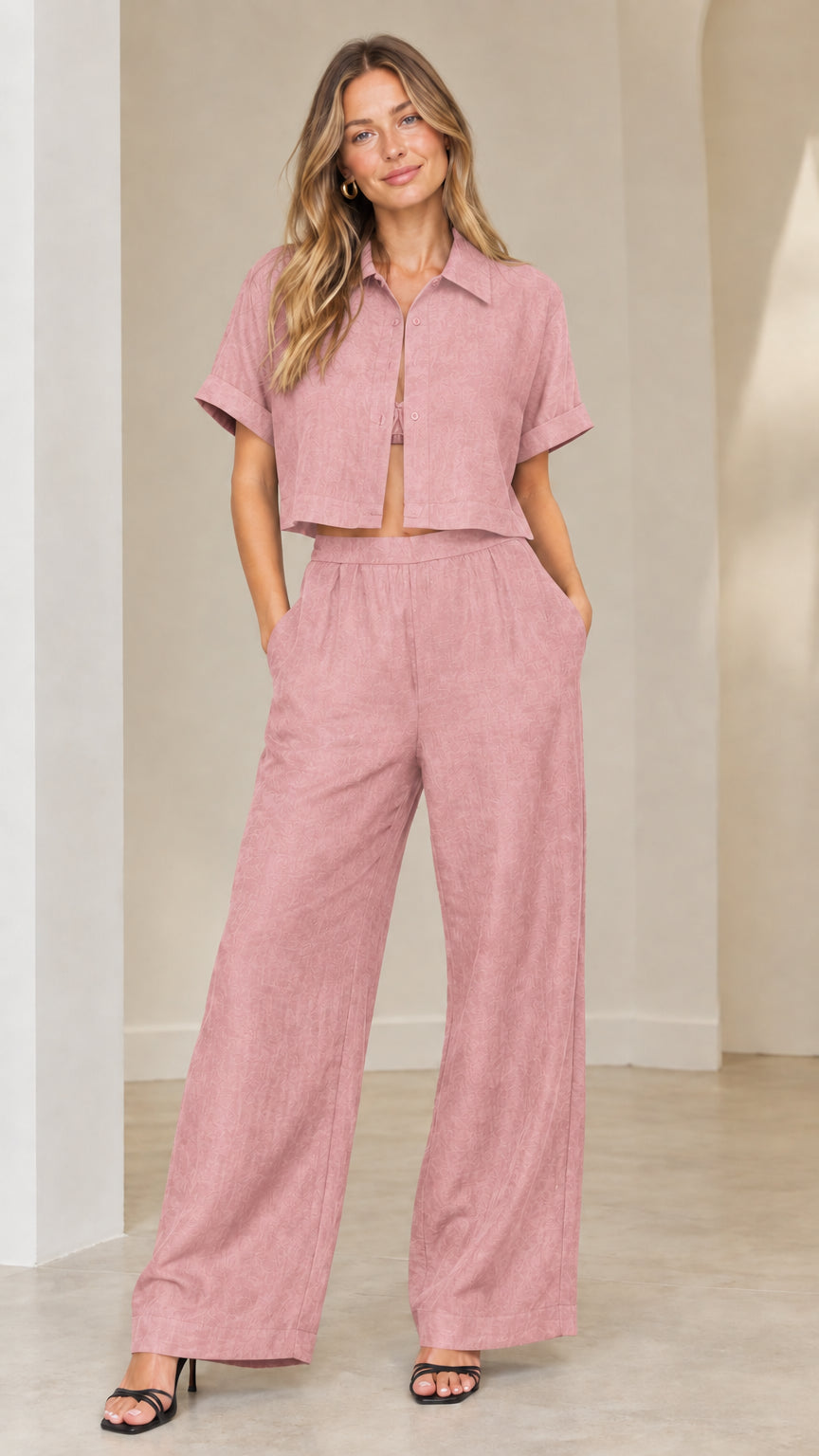 Front view of woman wearing dusty pink short-sleeve cropped shirt and wide-leg trousers set