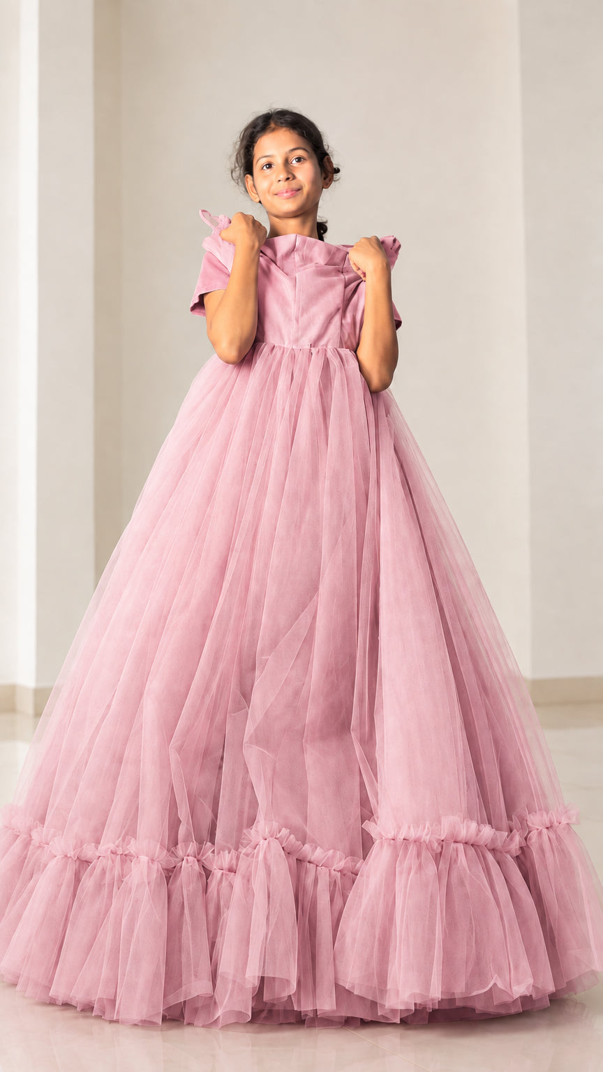 Front view of model showcasing dusty pink voluminous tulle evening dress