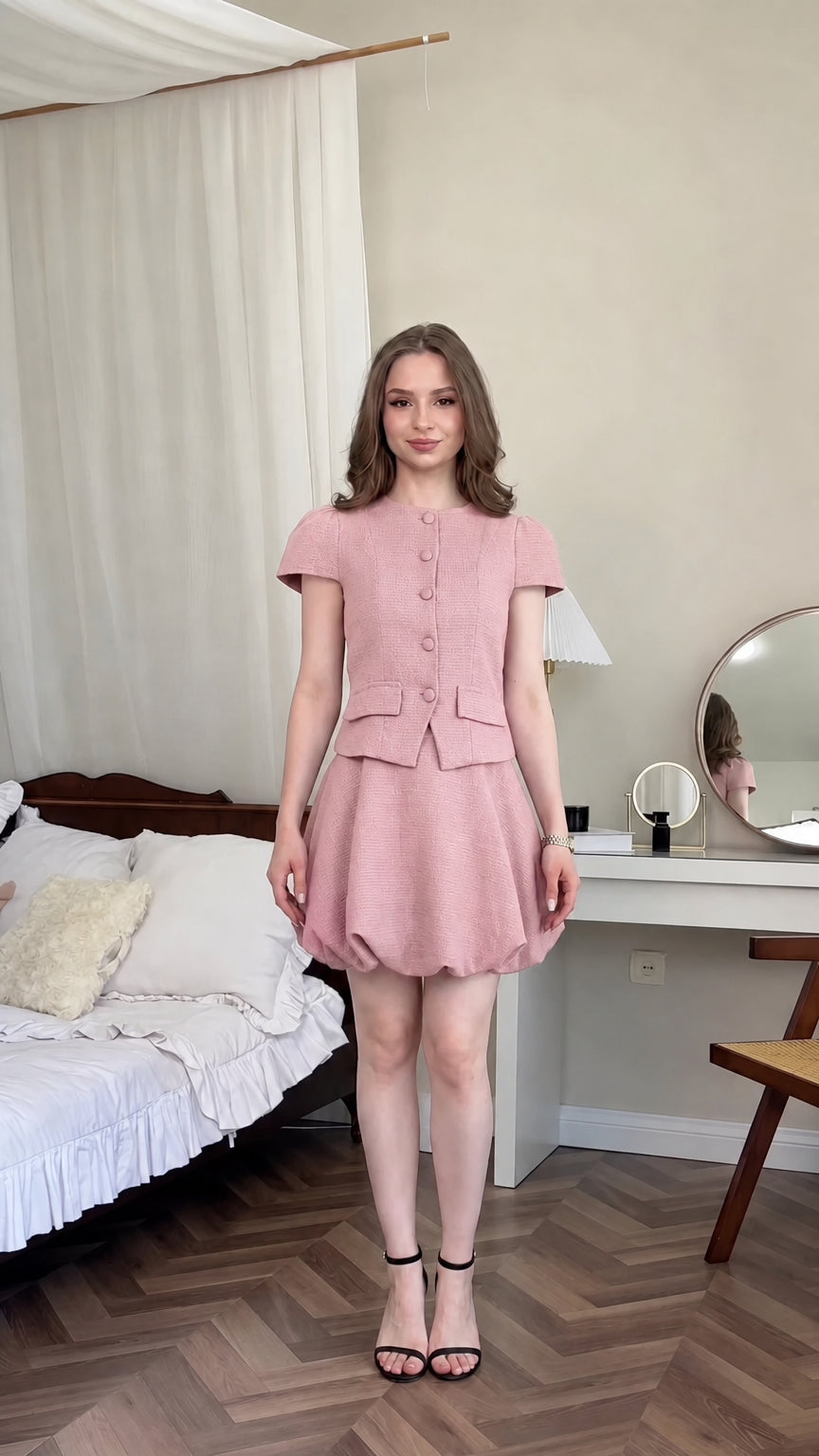 Front view of model wearing dusty pink tweed two-piece bubble skirt set