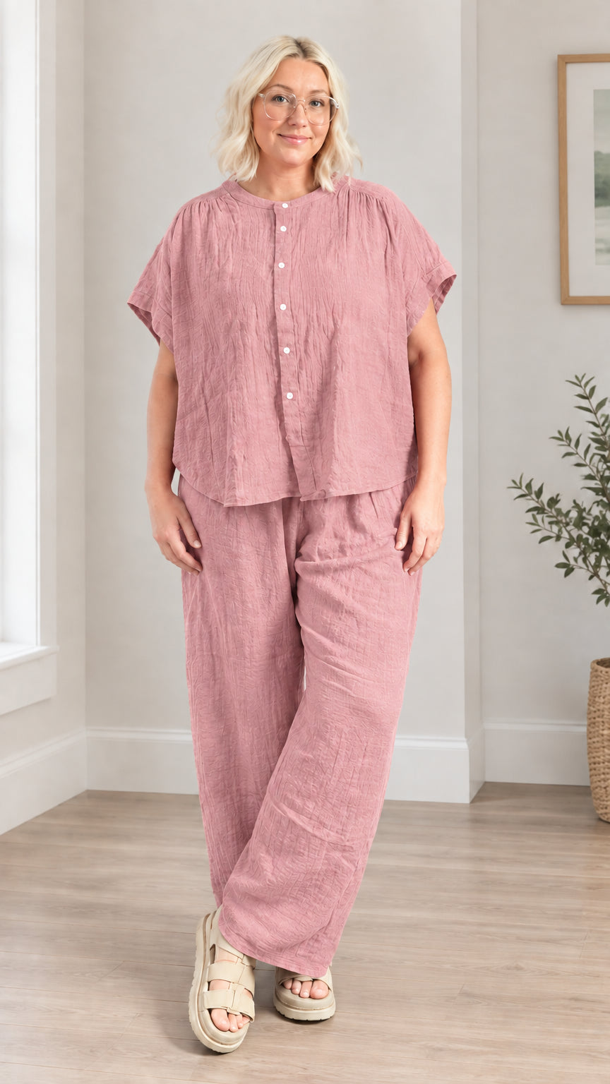 Model wearing dusty pink textured short-sleeve top and wide leg pants set