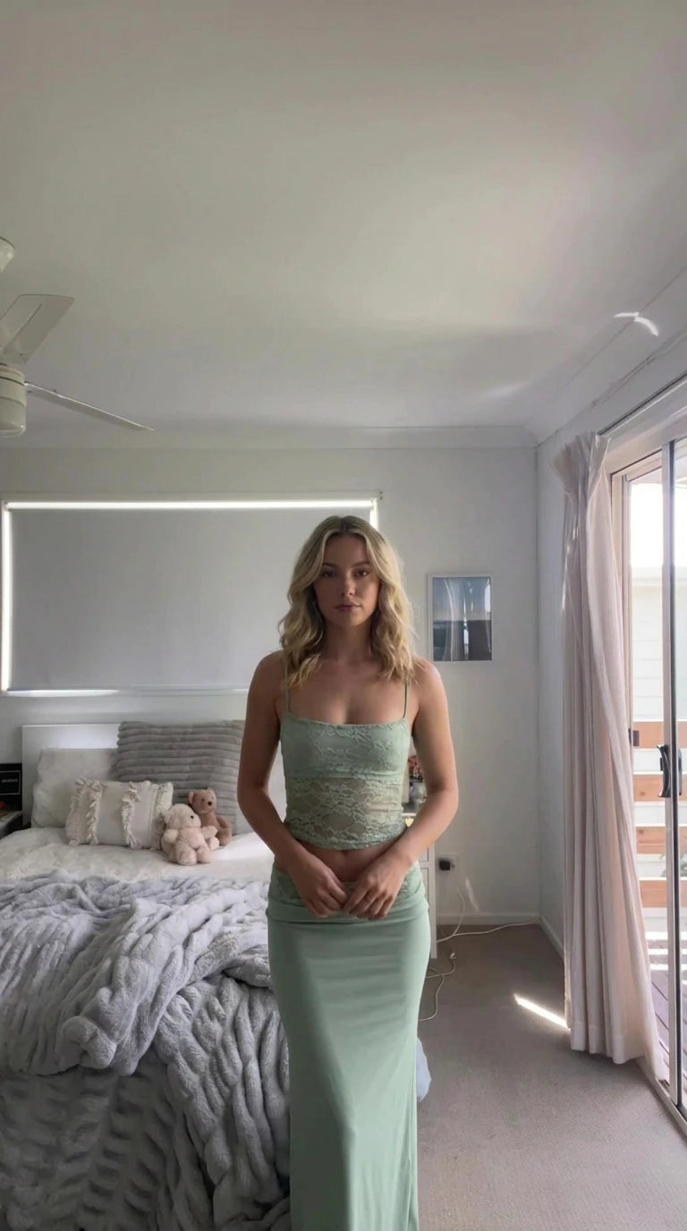 Model wearing sage green lace cami crop top and high-waisted maxi skirt set