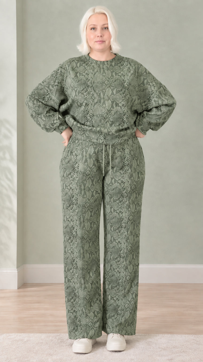 Woman wearing sage green snakeskin print sweatshirt and wide-leg pants set