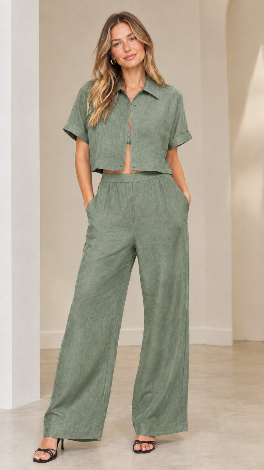 Front view of woman wearing sage green collared short-sleeve crop shirt and wide-leg pants set