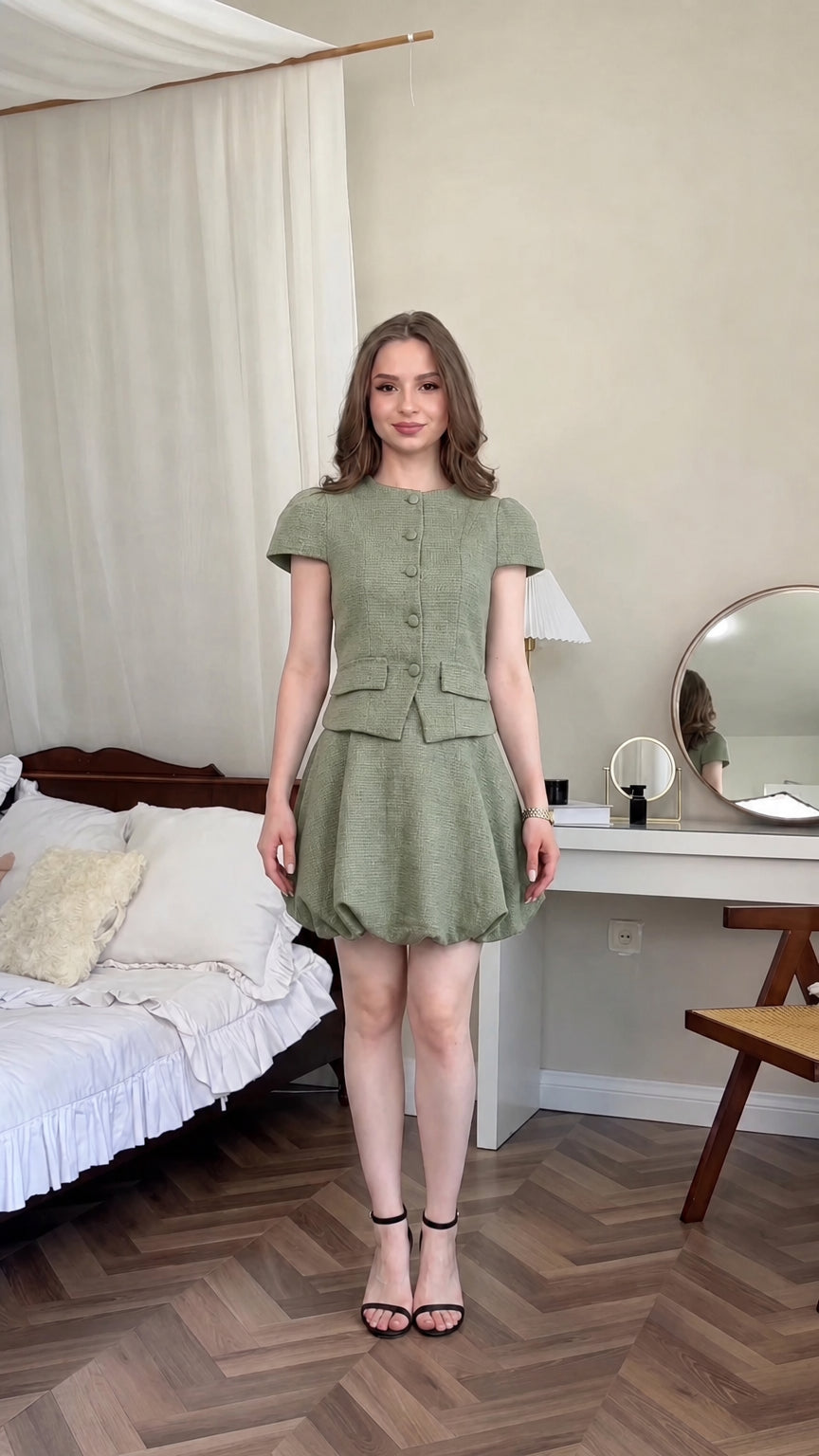 Front view of model wearing sage green tweed two-piece bubble skirt set