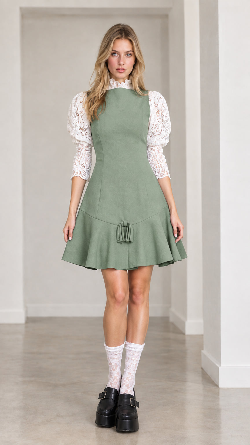 Front view of sage green contrast lace sleeve mini dress with tassel detail
