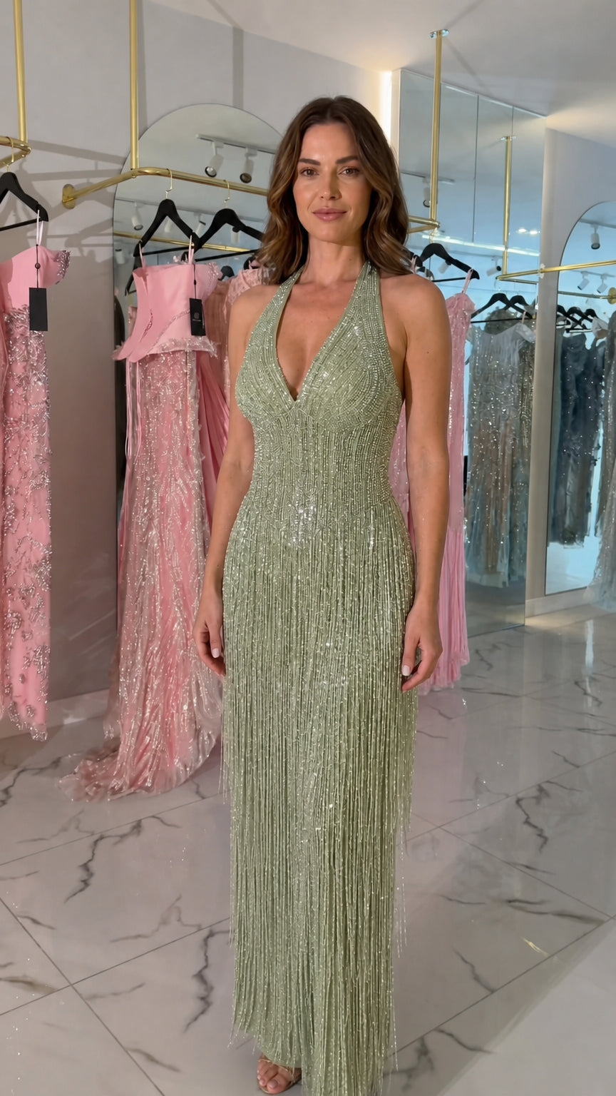Front view of woman wearing Sage Green halter sequined fringe evening gown