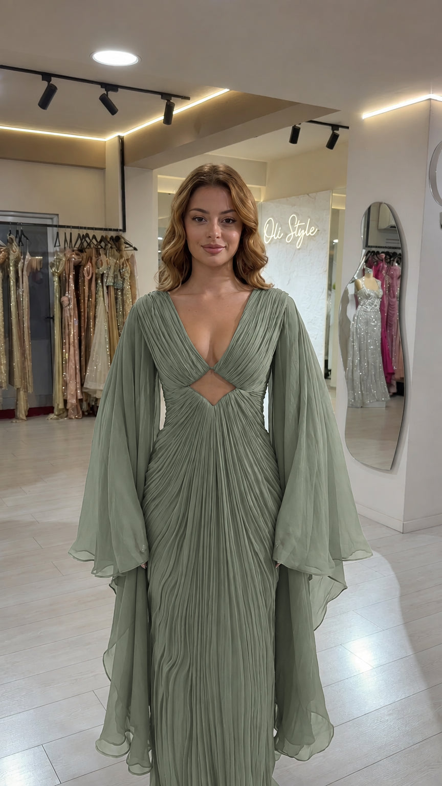 Full front view of sage green pleated cutout maxi gown with cape sleeves