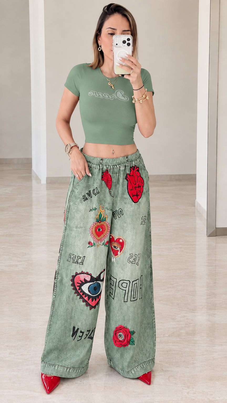 Front view of woman wearing sage green cropped tee with sage green wide-leg graphic pants