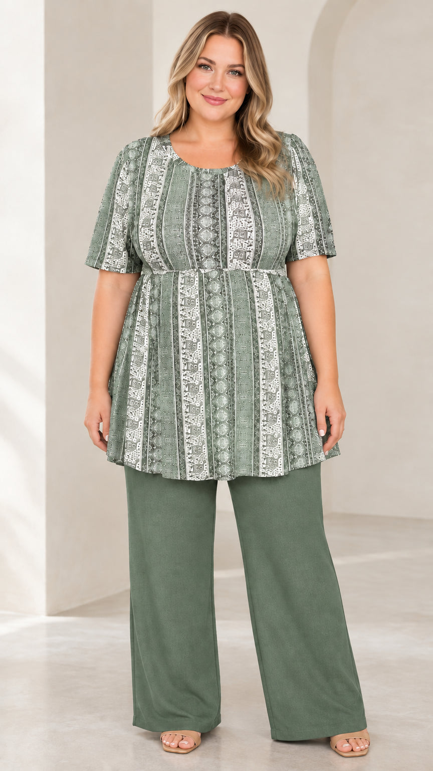 Model wearing Sage Green printed empire waist tunic paired with green wide leg pants